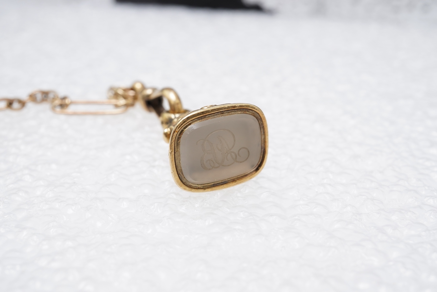 A gold watch chain, toothpick and fob seal